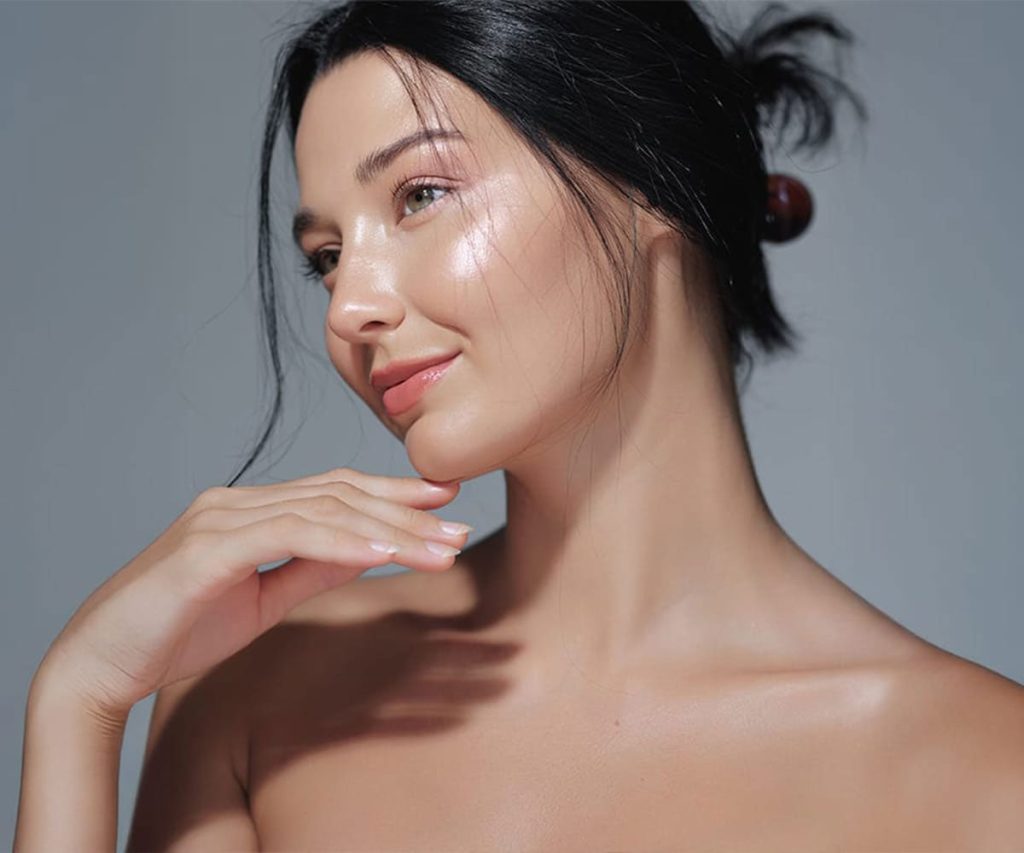Woman with healthy, glowing skin after a professional facial treatment