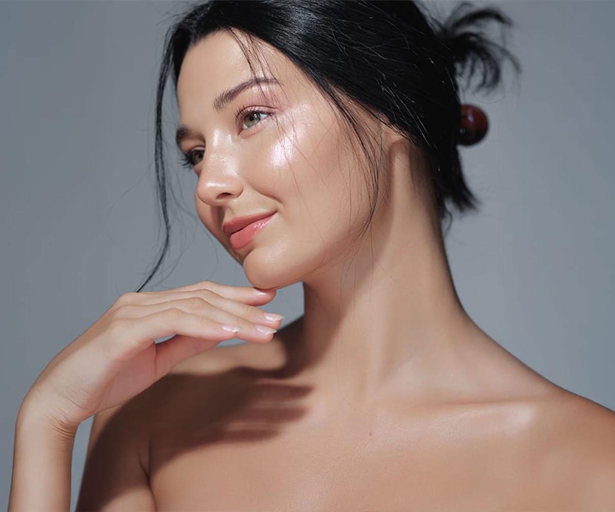 Woman with healthy, glowing skin after a professional facial treatment
